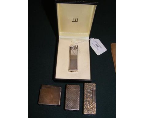 A vintage Dunhill lighter together with three others