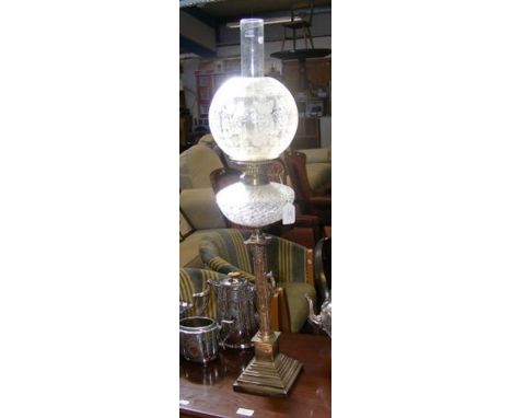 An antique silver oil lamp with cut glass reservoir and shade, having classic Corinthian column and vine leaf relief work dec