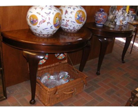 A pair of mahogany and walnut half moon console tables - width 120cms