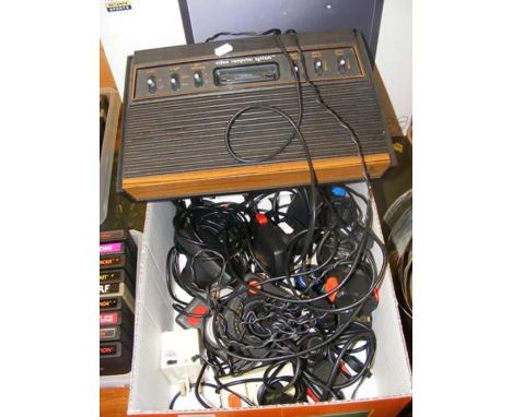 An Atari 2600 console with various joysticks and accessories 