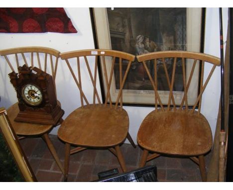 A set of four Ercol stick back retro dining chairs