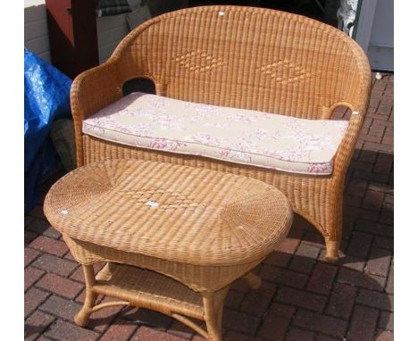 A cane conservatory sofa and coffee table