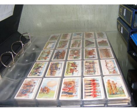 A large album containing collectable 1900-1920s cigarette card sets, including Players 1910 Army Life and 1912 Ships' Figureh