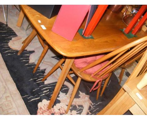 An Ercol dining table and four matching chairs 