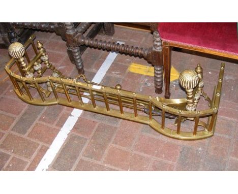 An antique brass fire fender together with tools