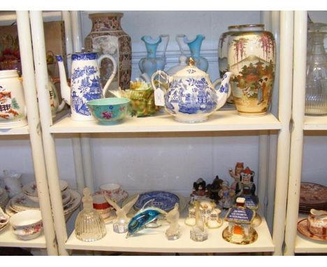 Two shelves of collectable ceramics and glassware, including oriental vases and Goebel paperweights 