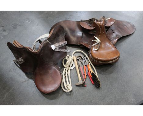 Two leather riding saddles, and quantity of tools, folding pocket knife, body armour, driving whip, etc. 