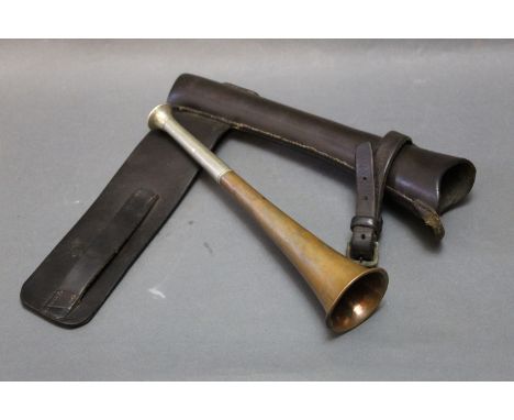 Copper hunting horn, length 23 cm, bell end diameter 54 mm, and a leather case for mounting to a saddle.  