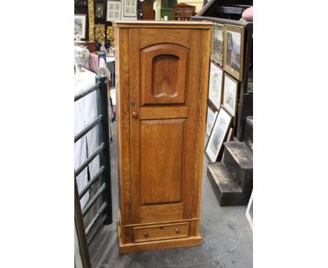 Gun cabinet disguised as an oak cupboard, opening to a metal lined interior fitted for 6 guns and with internal shelf, 2 sets