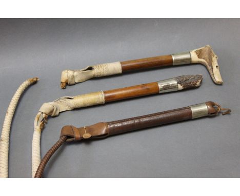 Three hunting whips, one with antler handle with combined whistle, silver coloured collar, malacca shaft, thong section and w