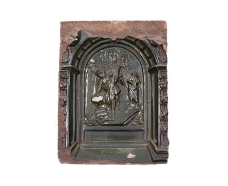 A Northern European pottery plaque, 17th century or later, with a dark green glaze, depicting classical figures on a rocky ou