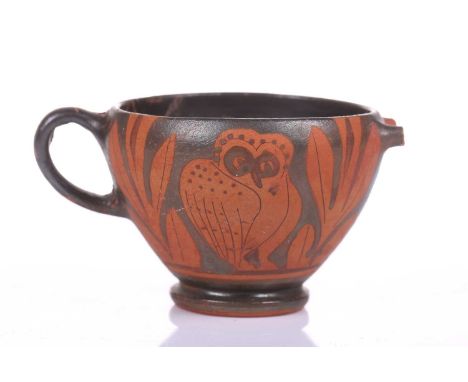An Athenian-style ritual cup, 4th century BC or later, decorated with the "Owl of Athena" amidst olive branches in red on a b