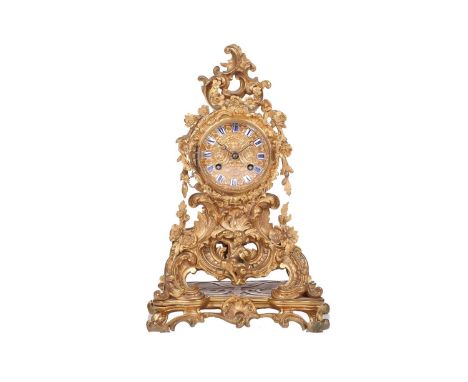 A late 19th century French ormolu clock, with floral garlands and scrolls, the gilt metal dial with enamelled hour markers, o