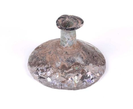 A large Roman glass conical flask of spreading circular form with irregular everted rim, signs of oxidation and soil encrusta