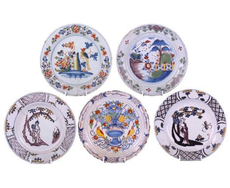 A group of five various English delft polychrome plates, including a Bristol example, circa 1735 decorated with a vase of flo