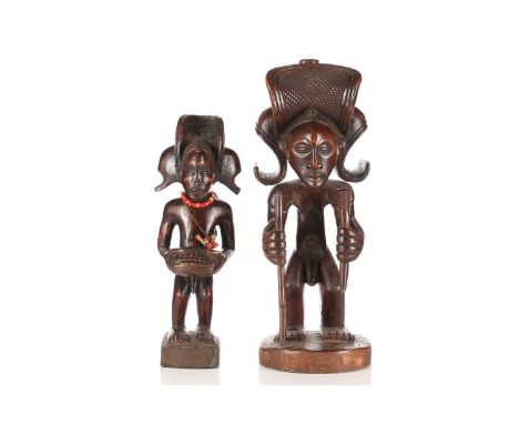 A Tchokwe (Chokwe) figure of Chibinda Ilunga, Democratic Republic of Congo, wearing a large headdress and holding a rifle and