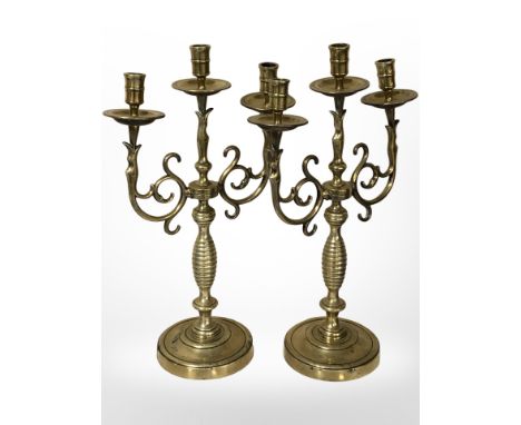 A pair of ornate brass triple-sconce candelabra, height 42cm.