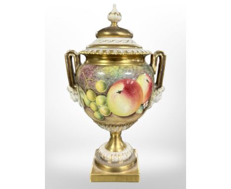 A Royal Worcester hand-painted porcelain twin-handled lidded urn, shape No. 2363, painted with panels of fruit by S. Roberts,