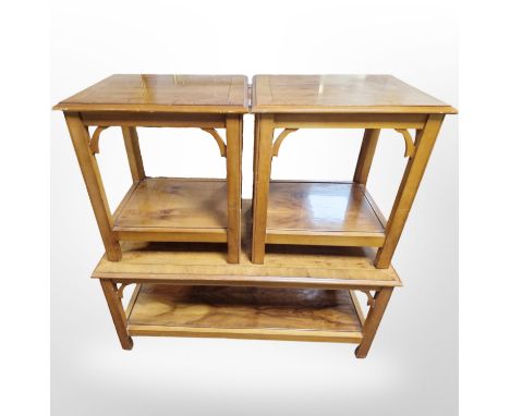 A reproduction yew wood coffee table, length 107 cm and pair of matching lamp tables 