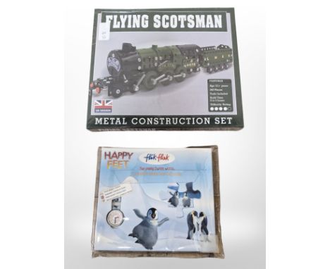 A Happy Feet child's Flik Flak Swatch Watch, together with a Flying Scotsman metal construction set, sealed in cellophane 