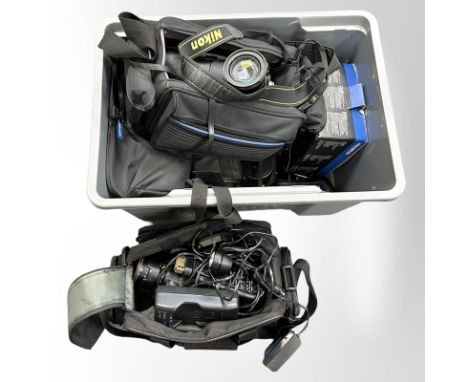 A crate containing a quantity of cameras and video recording equipment, to include Panasonic home video camera, Canon video c