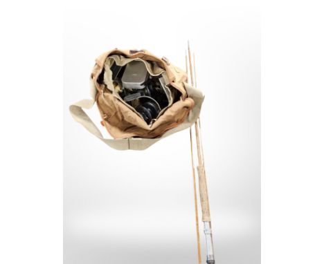A vintage three piece split cane fishing rod, together with a Billingham & Co canvas fishing bag containing several reels inc