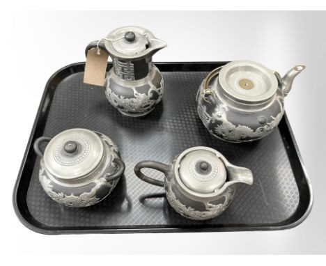 A four piece Chinese pottery tea service with pewter overlay. 