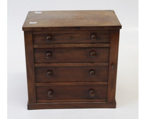 A mid Victorian figured mahogany table top specimen or jewellery box, the oblong top over four graduated drawers, raised on a