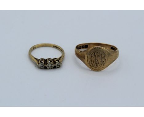 A collection of gold rings. Comprising a 9ct gold signet ring, size R; a 9ct gold three stone diamond ring, size K; a Sapphir