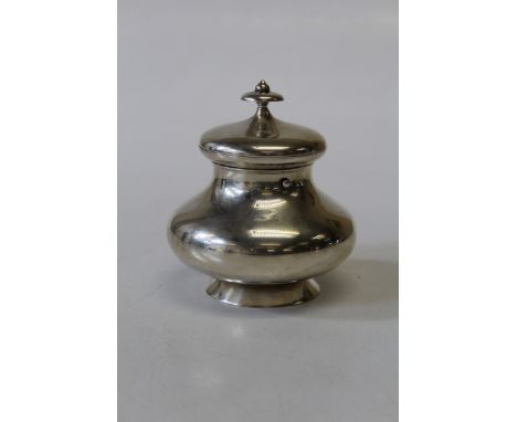A Dutch sterling silver circular baluster form tea caddy, with button fastener, hinged lid and knopp finial. With post Nether