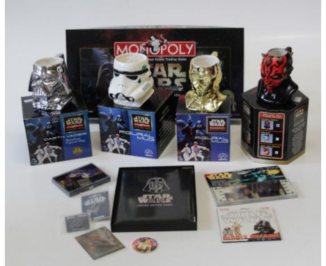 A collection of Stars Wars memorabilia including a Monopoly game, posters, videos and various cased mugs