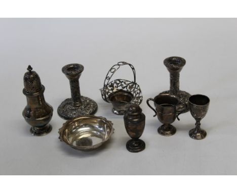 A pair of Queen Elizabeth II silver dwarf candlesticks, Birmingham 1989, 10cm, together with a small silver bonnet-form baske