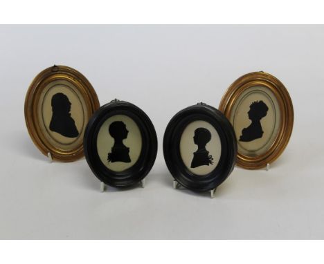 A pair of 19th century cut-card silhouette portrait miniatures, a lady and gentleman, each in oval gilt frame, 8 x 5cm, toget