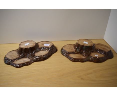 Two Beswick pottery tree trunk display stands.