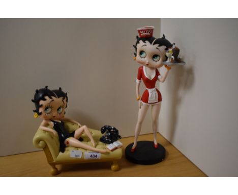 Two Betty Boop figurines, Betty on cream sofa and Betty diner waitress.