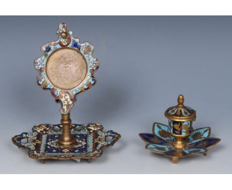 A French champleve enamel pocket watch stand, decorated in polychrome with flowers, scrolls and strapwork, dished base with h