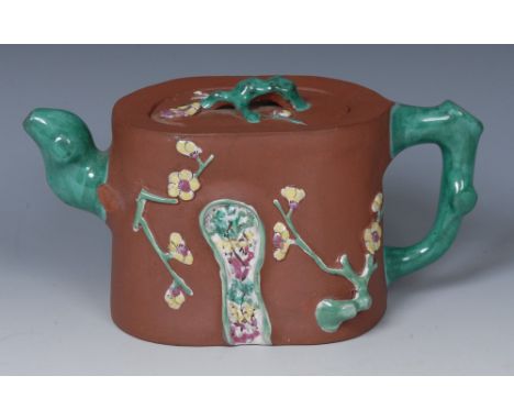 A Chinese Yixing terracotta teapot, applied with blossoming prunus decorated in polychrome, 18cm long, impressed seal mark