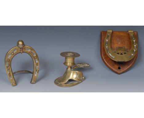 A 19th century brass novelty easel pocket watch and pen stand, as a horseshoe crested by a jockey cap, 13cm high, c.1890; a l