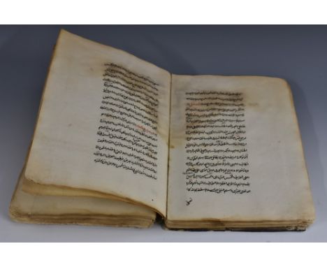 A 19th century or earlier Islamic religious manuscript, hand scrivened in black and red ink with Arabic script, papered marbl