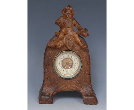 A Black Forest boudoir clock, 5cm circular enamel dial inscribed with Arabic numerals, keyless movement, the carved case cres
