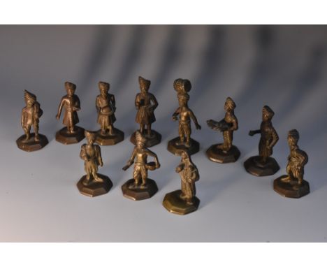 An interesting collection of Indian bronze figures, each cast as a Sikh, going about their daily life, octagonal bases, the t