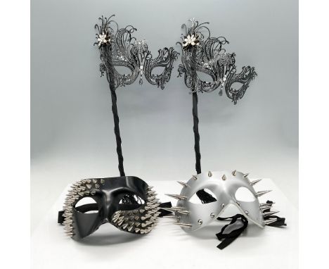 First mask is laser cut metal filigreed handheld black mask adorned with rhinestones and tassels (7.5"W x 14.5"H ). The secon