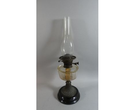 A Late 19th Century Oil Lamp with Glass Reservoir and Circular Stand 