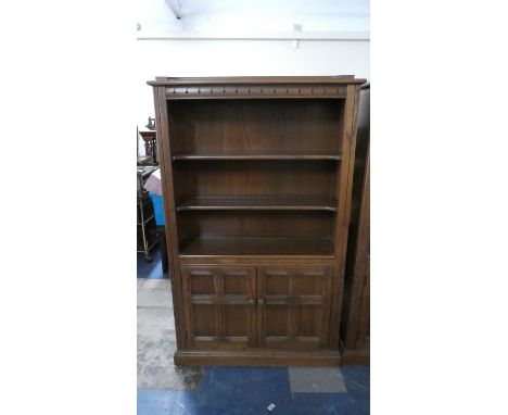 An Ercol Three Shelf Book Case with Panelled Doors to Base Cupboard, 94cm Wide 