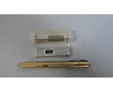 A Dunhill Cigarette Lighter, Silver Cigar Cutter and Retractable Knife 