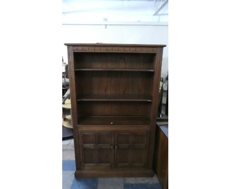 An Ercol Three Shelf Book Case with Panelled Doors to Base Cupboard, 94cm Wide 