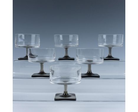This German glass set features elongated drinking glasses with smokey square bases. Marked Rosenthal. R mark etched. Issued: 
