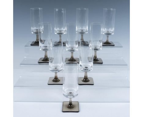 This German glass set features elongated drinking glasses with smokey square bases. Marked Rosenthal. R mark etched. Issued: 