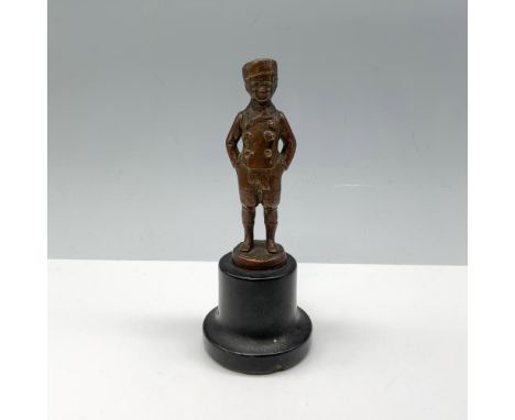 Charming figure of a young man atop a pedestal modeling a scarf with his hands in his pockets. Issued: 20th centuryDimensions
