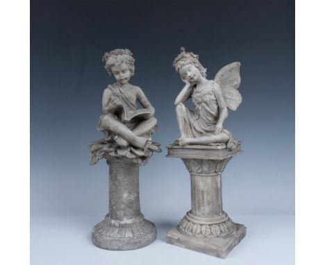 Fantastic duo of statuettes that includes a robed child sitting on a sunflower scrolling through a book, and a fairy with a l